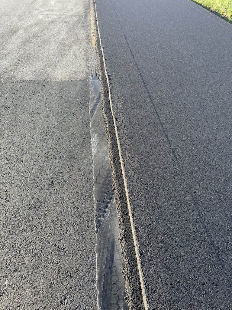 close up of a half paved asphalt mat