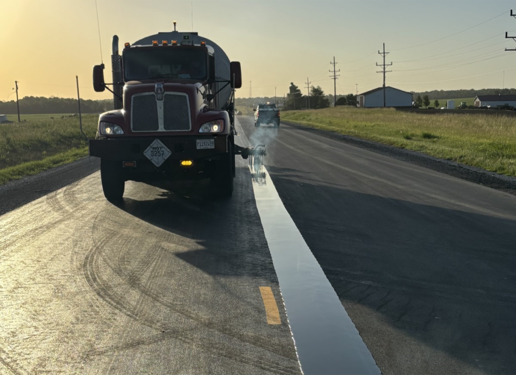 A road at sunrise is receiving an 18in wide band of J-Band to the centerline joint.