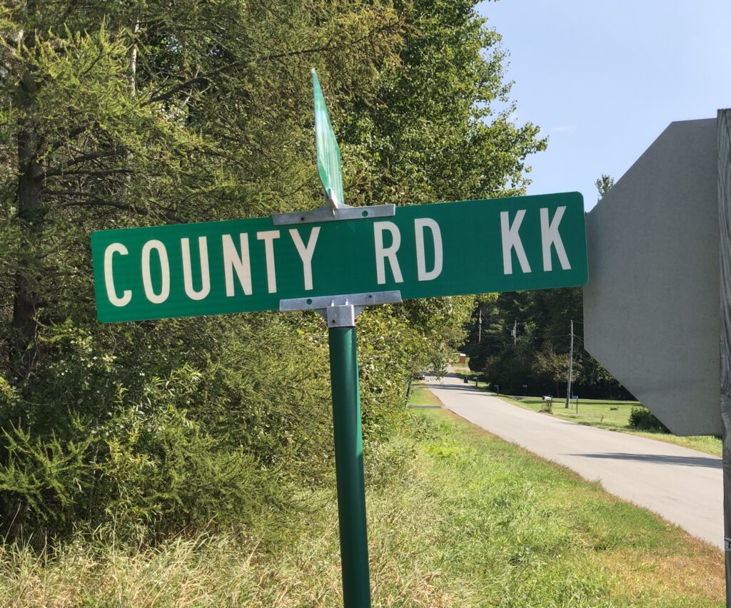 sign displaying County Road KK, the road receiving VRAM for safety